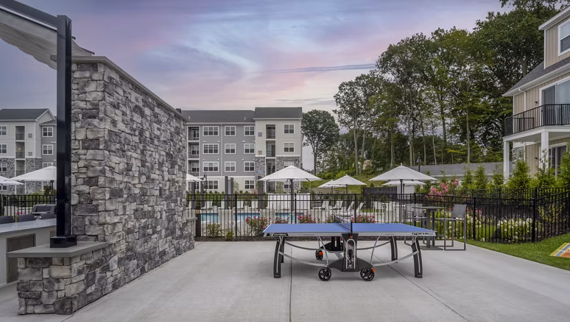 Courtyard featuring lush greenery at Woodside Trumbull Apartments, offering luxurious outdoor spaces for relaxation and leisure