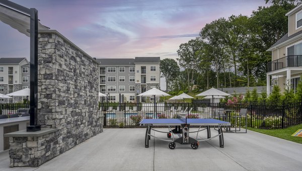 Courtyard featuring lush greenery at Woodside Trumbull Apartments, offering luxurious outdoor spaces for relaxation and leisure