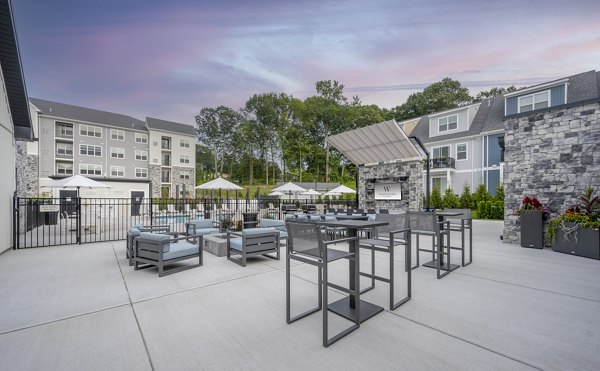 Courtyard at Woodside Trumbull Apartments featuring lush landscaping and communal seating areas
