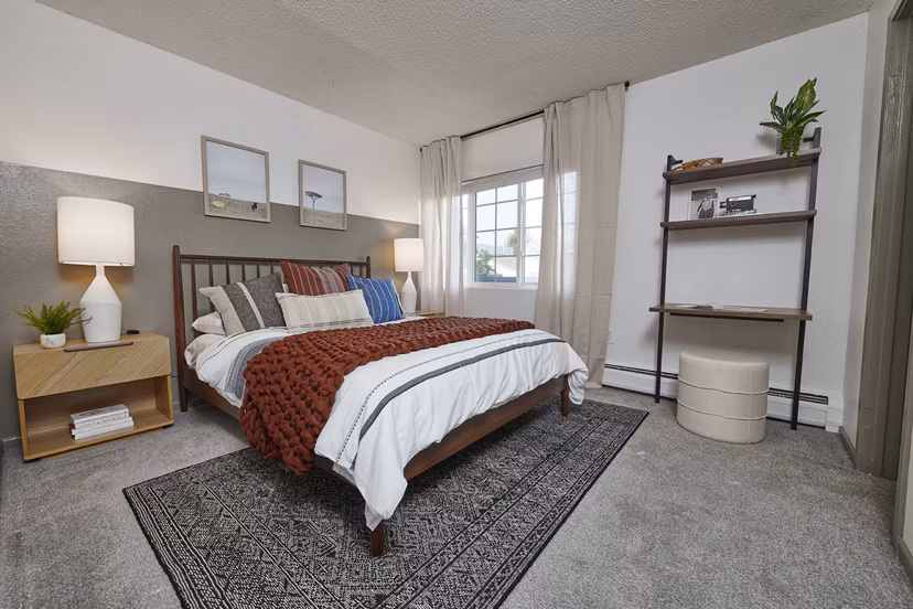 Cozy bedroom with modern furnishings in Novi at Lowry Apartments, offering a comfortable living space for residents