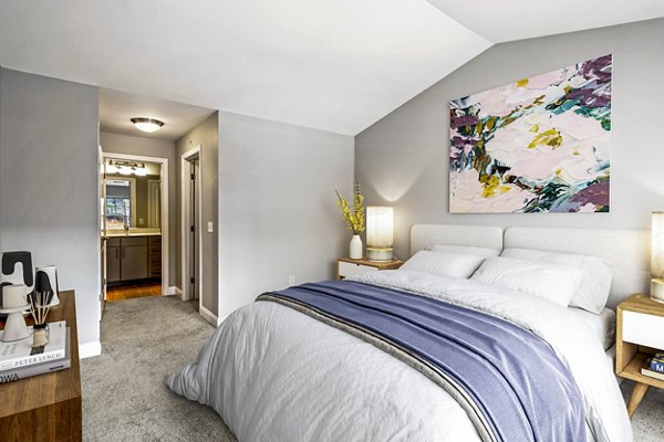 Bedroom featuring modern decor and ample natural light at The Preserve at Cohasset Apartments