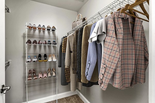 Bedroom closet with built-in shelving and ample storage space in The Preserve at Cohasset Apartments