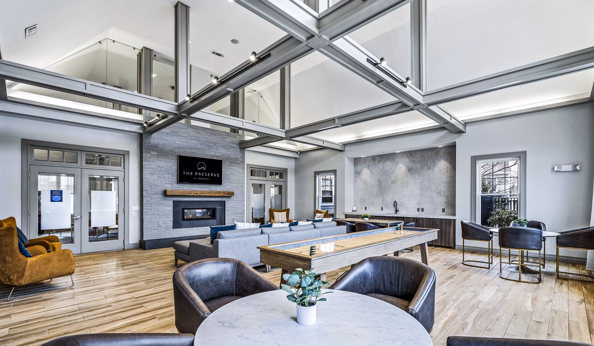 Clubhouse with cozy seating and modern decor at The Preserve at Cohasset Apartments, perfect for gatherings and relaxation