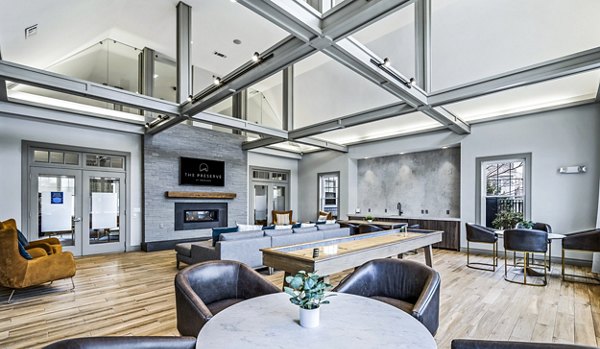 Clubhouse with cozy seating and modern decor at The Preserve at Cohasset Apartments, perfect for gatherings and relaxation