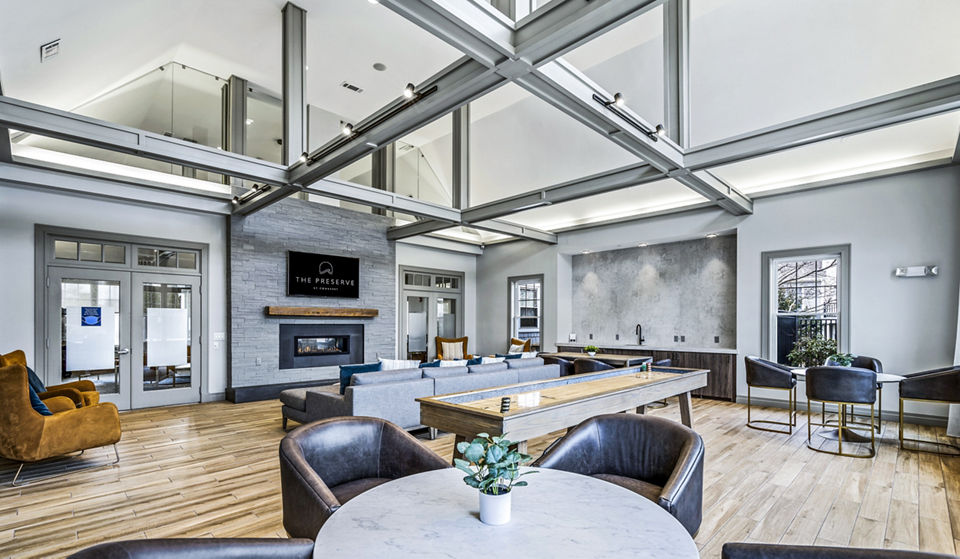 Clubhouse with cozy seating and modern decor at The Preserve at Cohasset Apartments, perfect for gatherings and relaxation