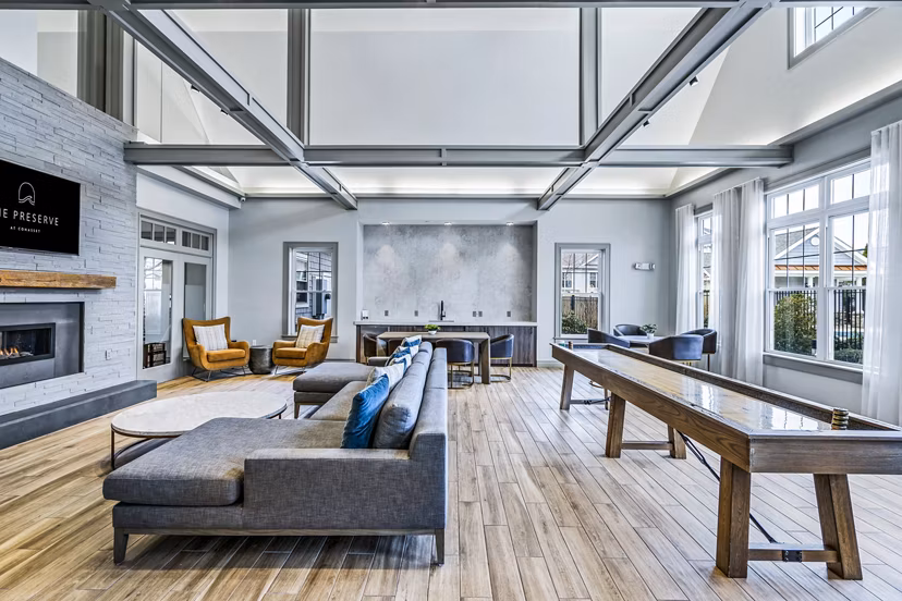 Modern clubhouse with cozy seating at The Preserve at Cohasset Apartments