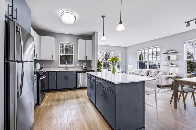 Kitchen featuring modern appliances and sleek countertops at The Preserve at Cohasset Apartments
