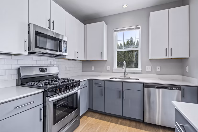 Modern kitchen featuring stainless steel appliances at The Preserve at Cohasset Apartments