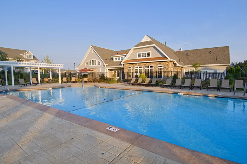 Outdoor swimming pool & barbecue area at Avalon Cohasset luxury apartments, ideal for relaxation and entertainment in Massachusetts