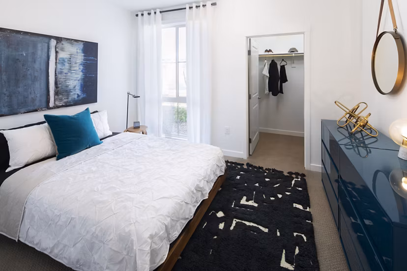 Bedroom with elegant decor and neutral tones at The Well Apartments