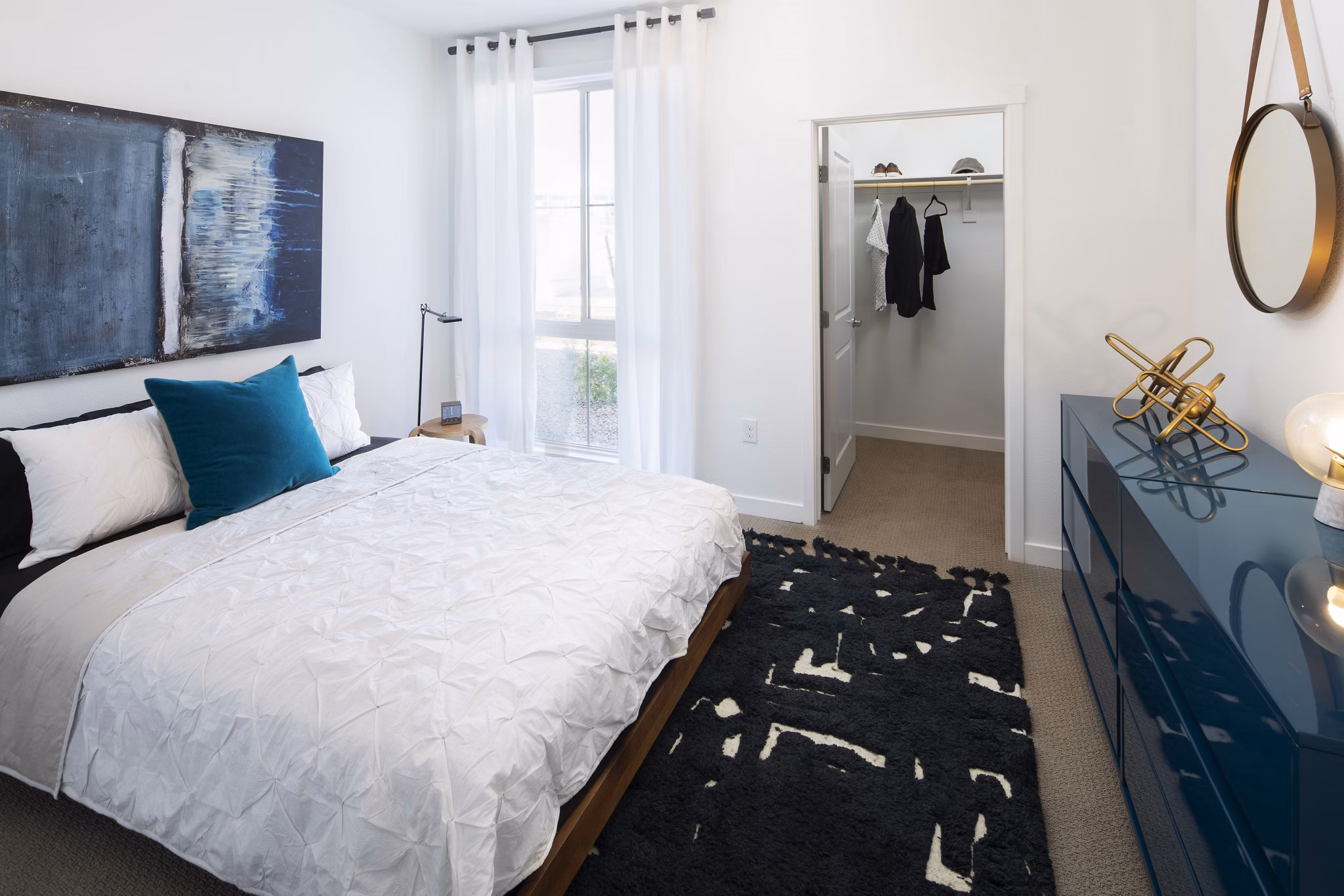 Bedroom with elegant decor and neutral tones at The Well Apartments