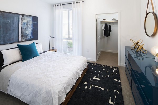 Bedroom with elegant decor and neutral tones at The Well Apartments