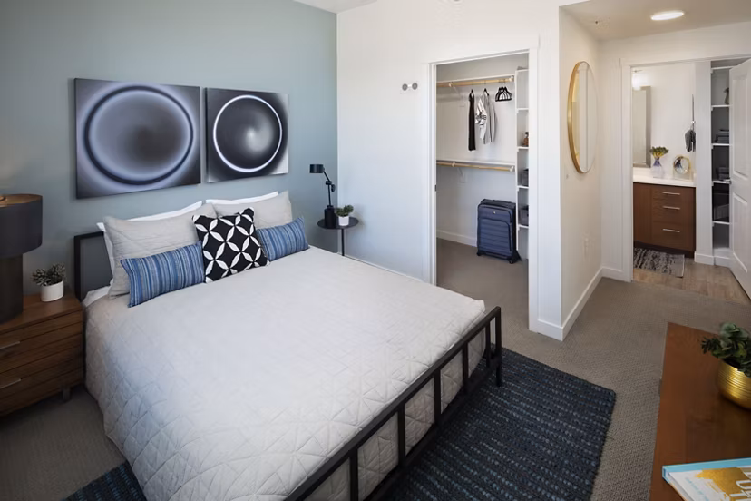 Bedroom with modern design and natural lighting at The Well Apartments