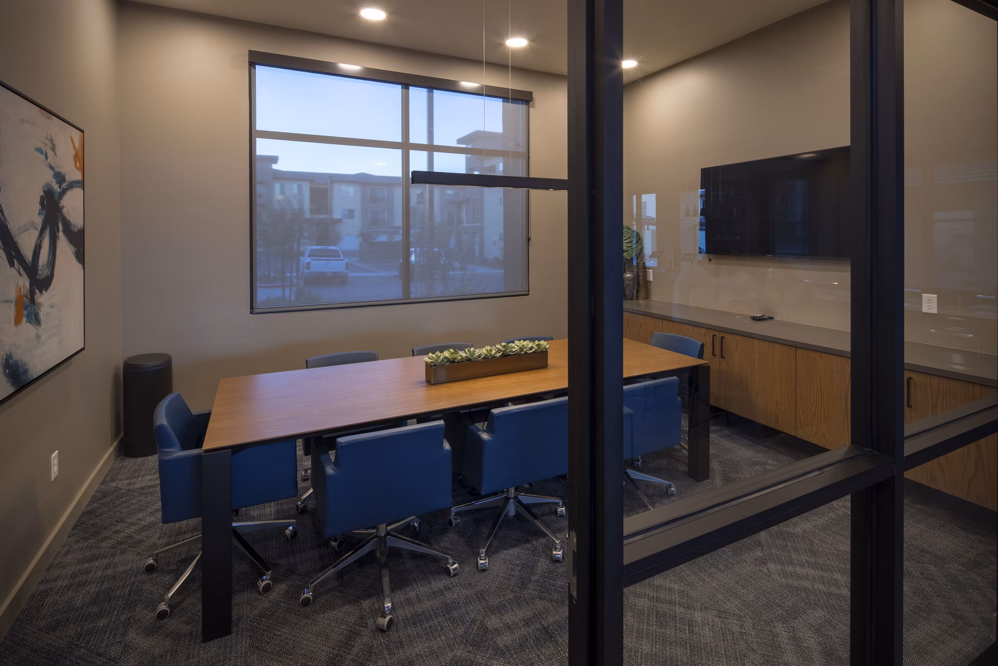 State-of-the-art meeting facility at The Well Apartments with modern seating and presentation equipment, ideal for luxury apartment residents