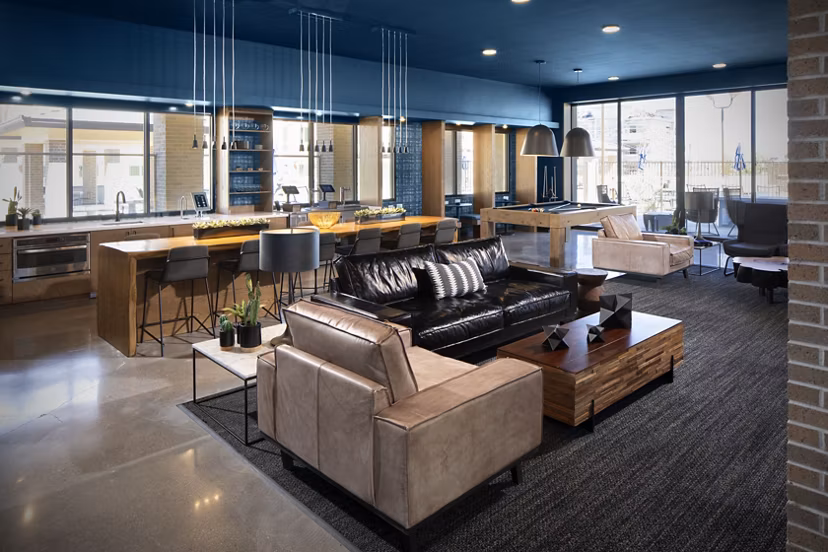 Clubhouse at The Well Apartments featuring modern design and comfortable lounge spaces for residents in a luxury community