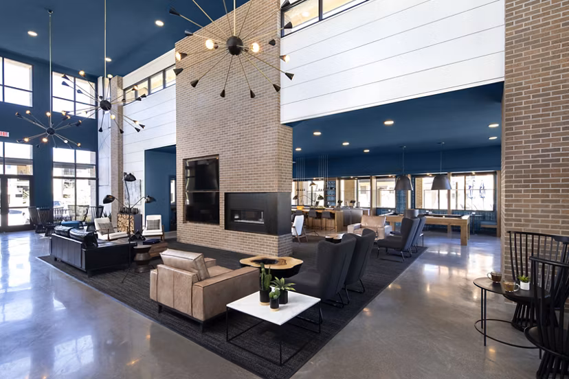 Clubhouse with modern seating and entertainment options at The Well Apartments in Henderson, NV.