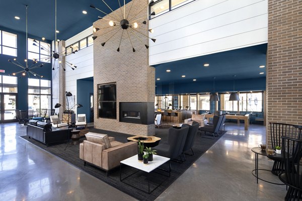 Clubhouse with modern seating and entertainment options at The Well Apartments in Henderson, NV.