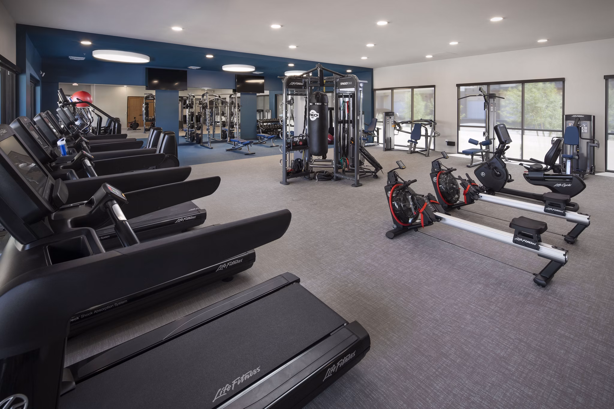 Modern fitness center with state-of-the-art equipment at The Well Apartments
