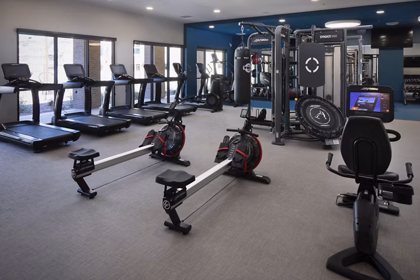 State-of-the-art fitness center with modern equipment at The Well Apartments, providing luxury workout amenities for residents