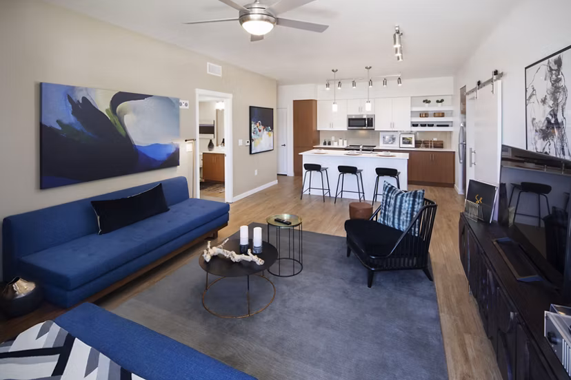 Spacious living room with modern furnishings at The Well Apartments