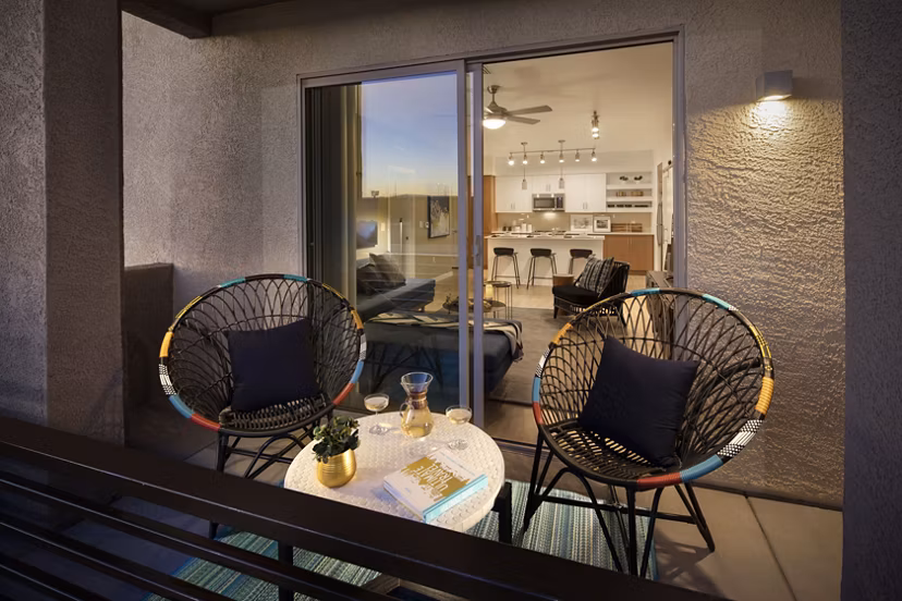 Spacious outdoor patio with modern seating at The Well Apartments in prime location for relaxation and gatherings