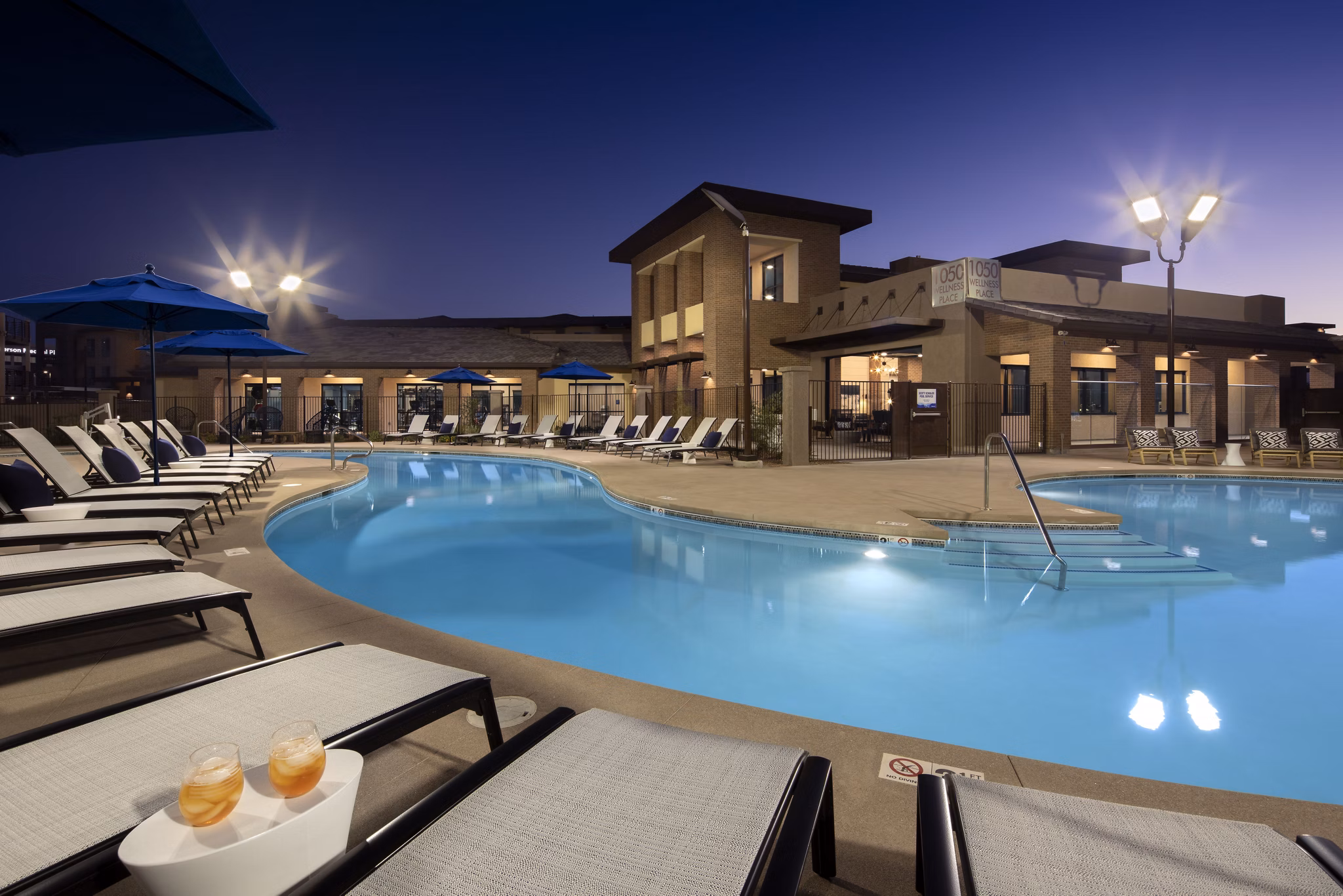 Luxurious pool with stylish lounge areas at The Well Apartments