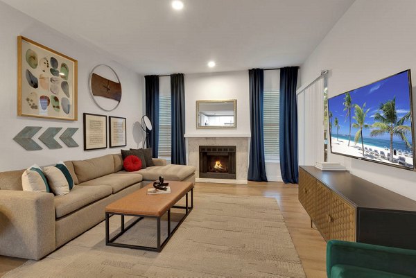 Spacious living room with modern furniture and large windows in The Marks Apartments, ideal for luxury living in a Greystar-managed community