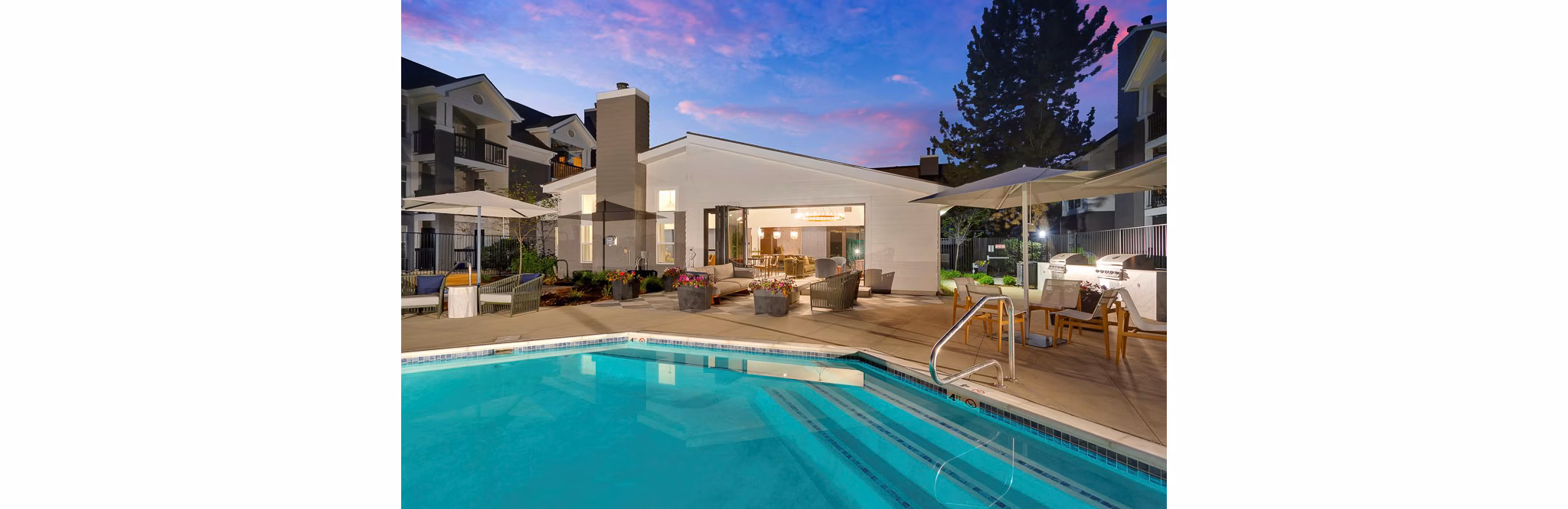 Luxury pool with lounge chairs at The Marks Apartments: upscale living in vibrant community
