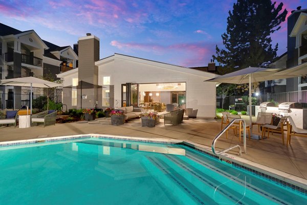 Luxury pool with lounge chairs at The Marks Apartments: upscale living in vibrant community