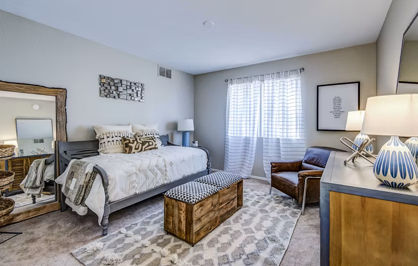 Elegant bedroom featuring sleek design and large windows at HUE97 Apartments