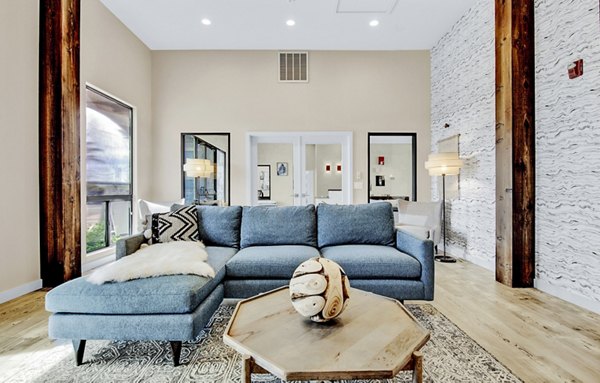 Elegant clubhouse/lounge area at HUE97 Apartments with modern decor and seating