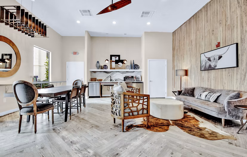 Modern clubhouse lobby with stylish seating and art displays at HUE97 Apartments, offering luxury living by Greystar