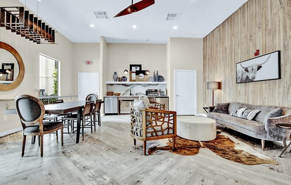 Modern clubhouse lobby with stylish seating and art displays at HUE97 Apartments, offering luxury living by Greystar