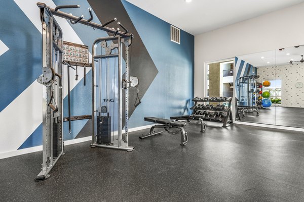 Modern fitness center with state-of-the-art equipment at HUE97 Apartments