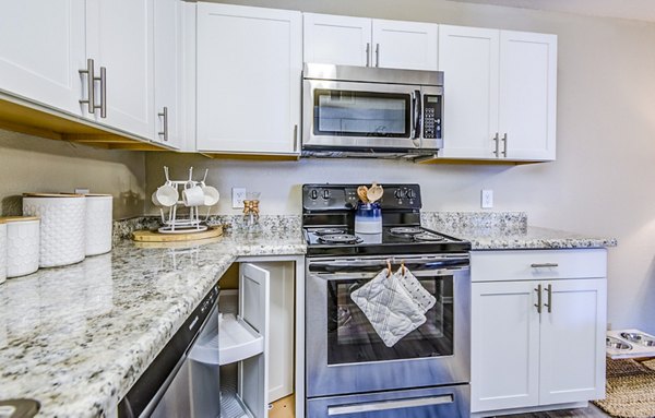 Modern kitchen with stainless steel appliances at HUE97 Apartments