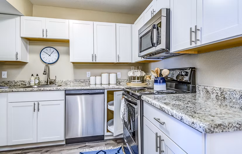 Modern kitchen with stainless steel appliances at HUE97 Apartments offering luxurious living in a Greystar community