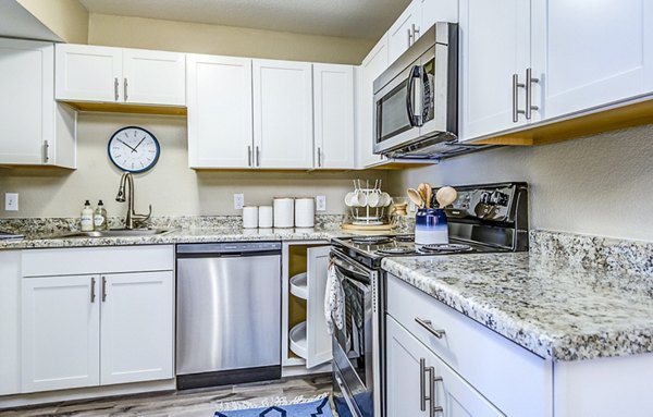 Modern kitchen with stainless steel appliances at HUE97 Apartments offering luxurious living in a Greystar community