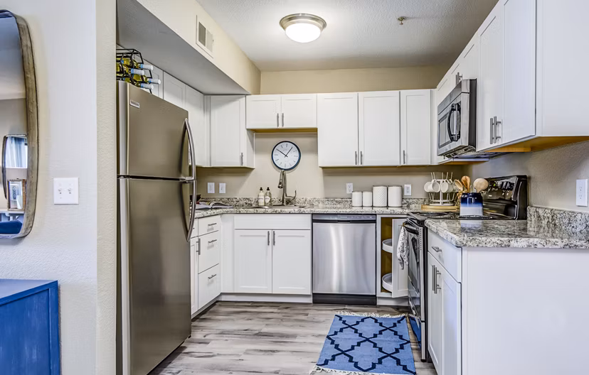 Modern kitchen with sleek countertops and stainless steel appliances in HUE97 Apartments