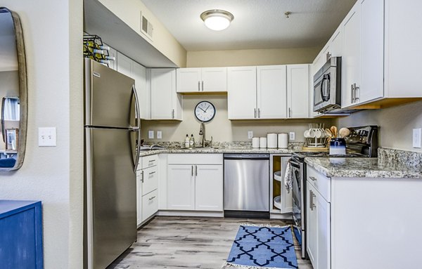 Modern kitchen with sleek countertops and stainless steel appliances in HUE97 Apartments