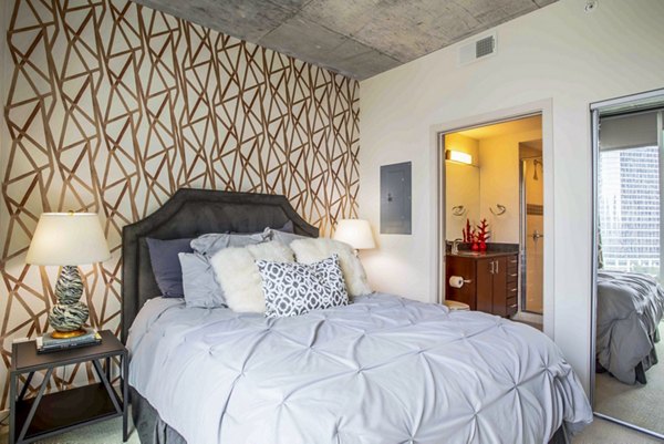 Spacious bedroom with modern decor and ample natural light at SoDo on Main North Apartments