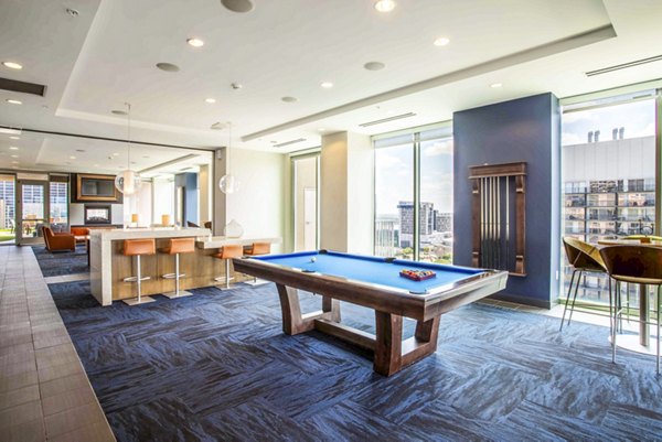 Clubhouse game room with billiards and modern seating at SoDo on Main North Apartments