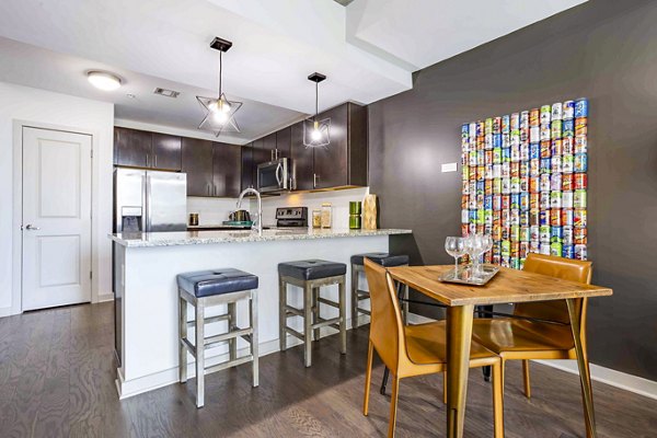 Dining room featuring modern decor and large windows at SoDo on Main North Apartments