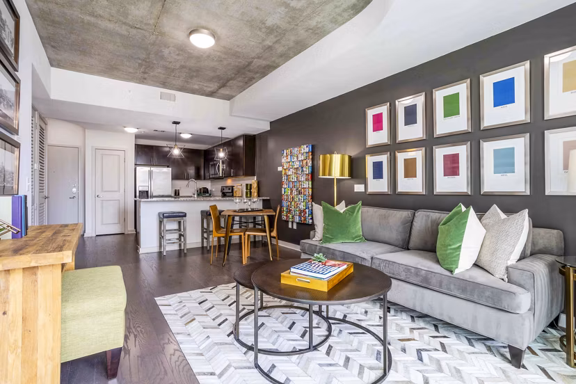 Living room featuring a cozy sofa and modern decor at SoDo on Main North Apartments