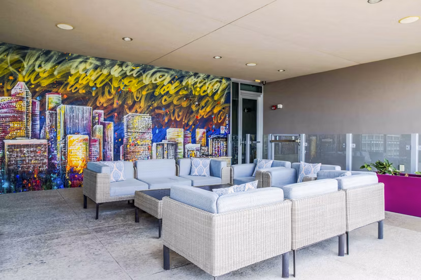 Contemporary patio space at SoDo on Main North Apartments featuring stylish outdoor seating and lush greenery