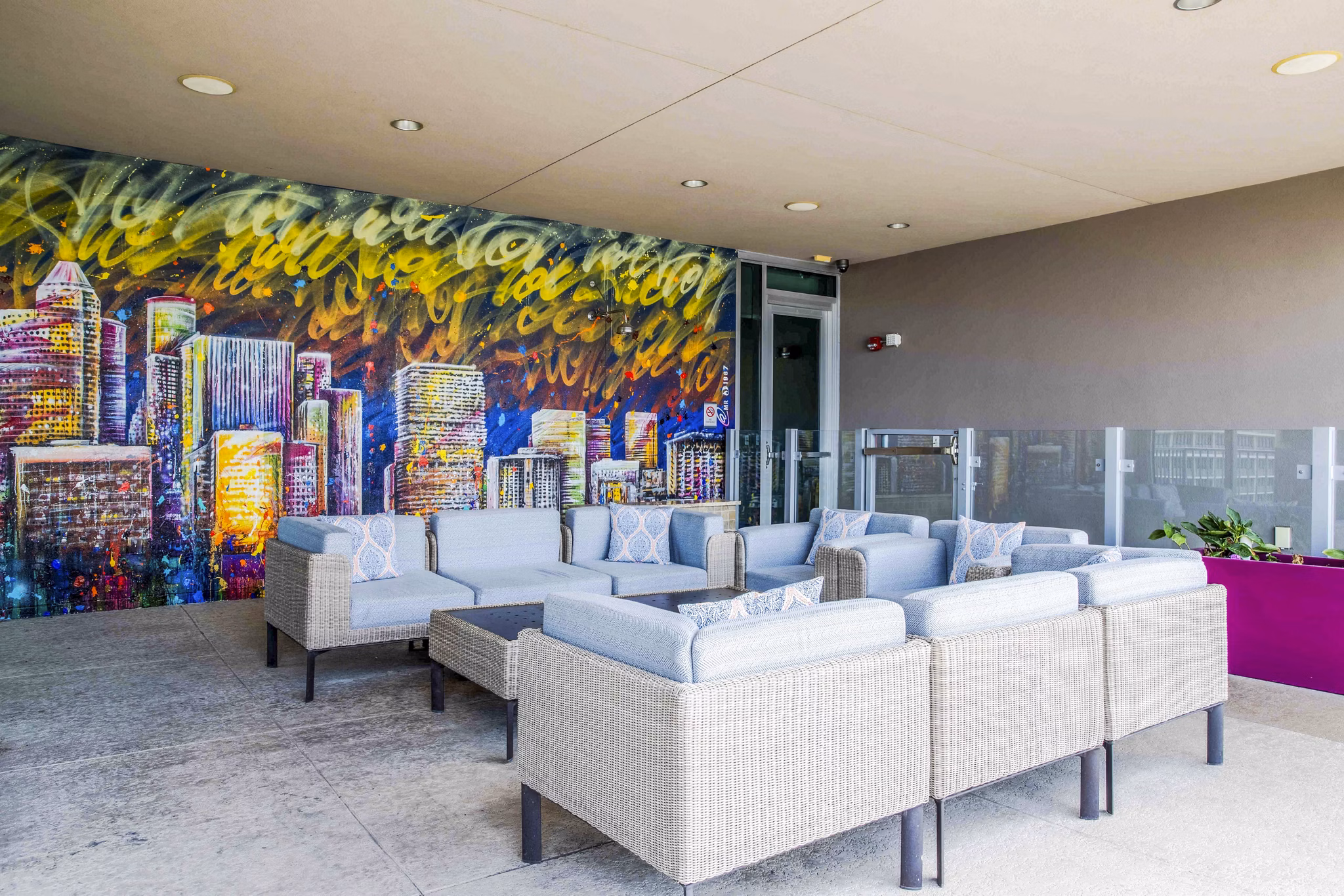 Contemporary patio space at SoDo on Main North Apartments featuring stylish outdoor seating and lush greenery