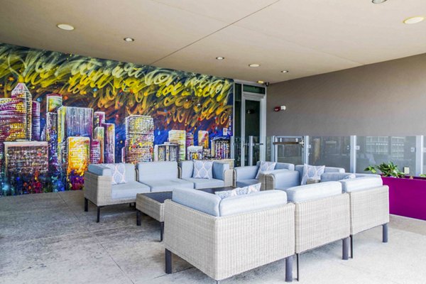 Contemporary patio space at SoDo on Main North Apartments featuring stylish outdoor seating and lush greenery