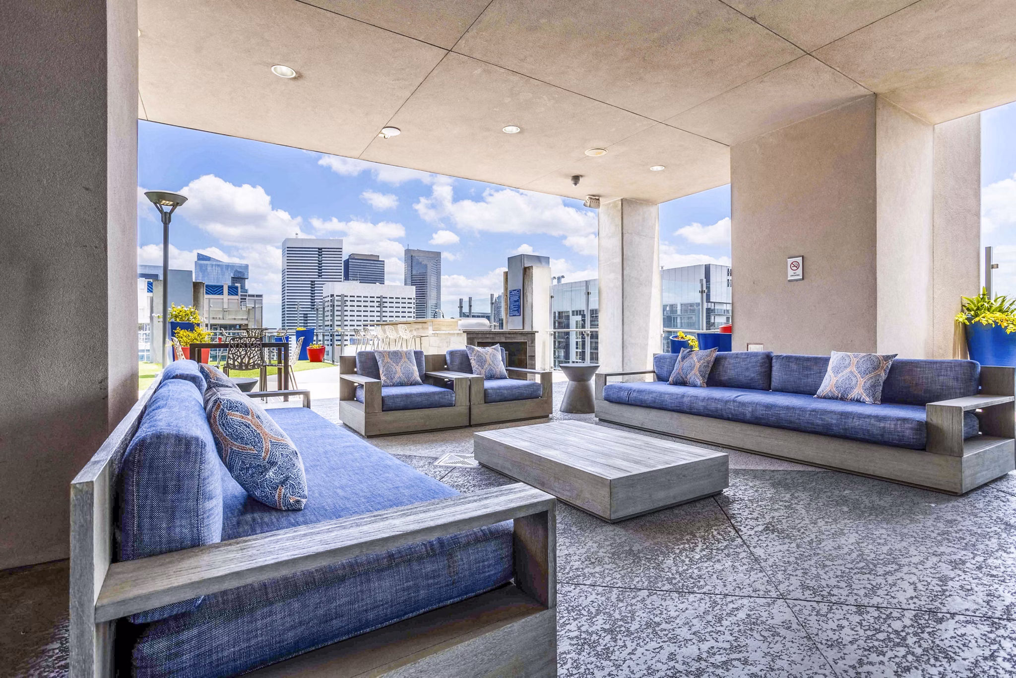 Modern outdoor patio at SoDo on Main North Apartments featuring comfortable seating and greenery