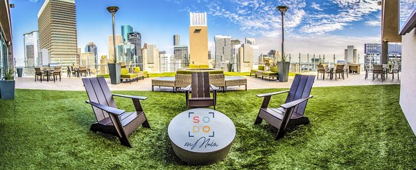 Spacious outdoor patio with modern seating at SoDo on Main North Apartments