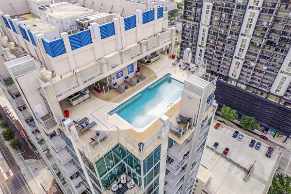 SoDo on Main North Apartments: Modern pool area with comfortable lounge chairs and landscaping