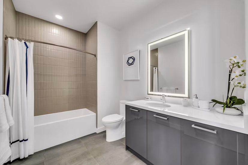 Bathroom with modern fixtures and marble countertops in Kurve Apartments, a luxury Greystar property